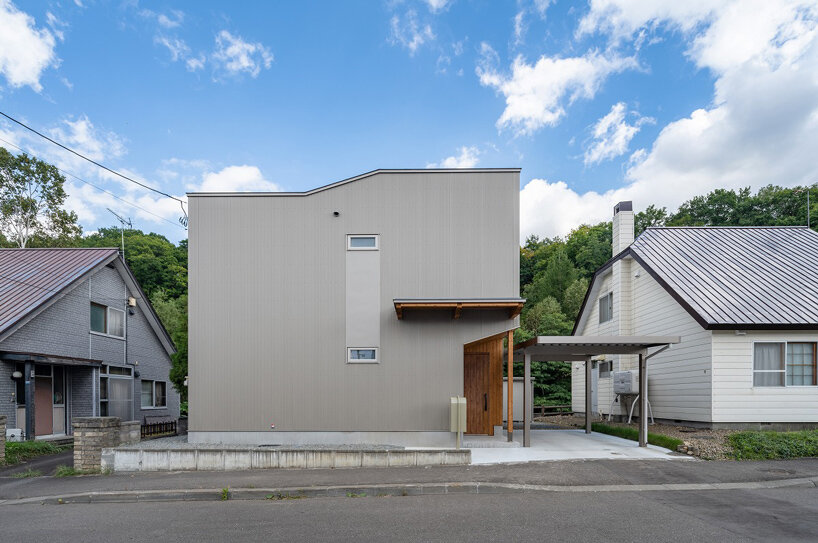 split-level timber house organizes layered interiors around japanese forest landscape - 2